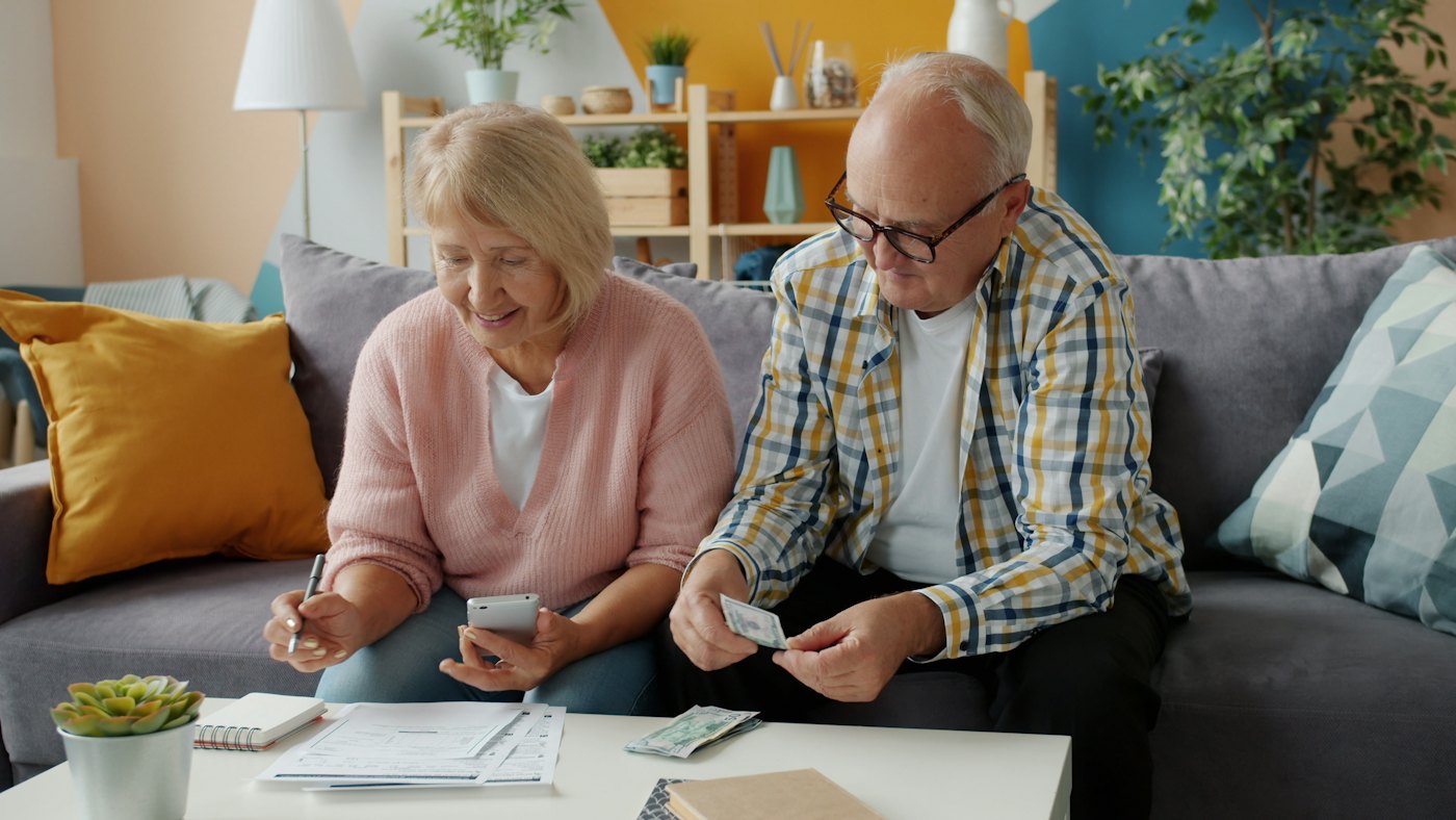 A retired couple working through their finances at home